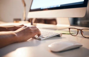 Trasmissione telematica delle istanze VIA dal 1° febbraio Computer, keyboard and night with business hands typing for online market research, website copywriting or email communication. Desktop, modern office desk and online writer with blog inspiration